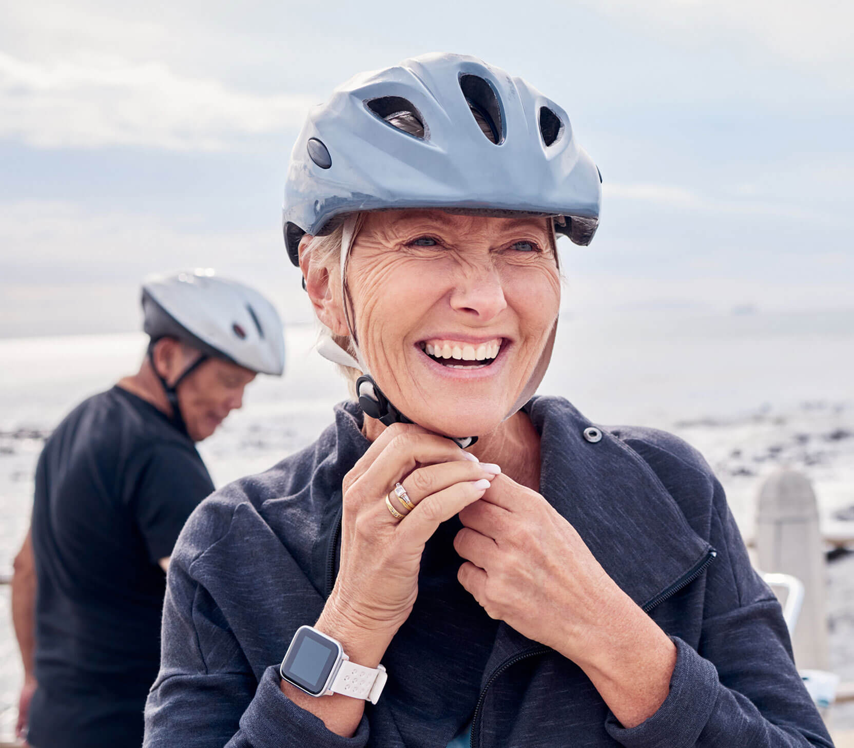 older woman cycling with helmet